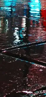 Colorful city night reflection on wet street pavement.