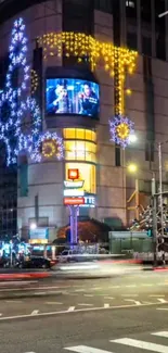 Vibrant city street with colorful holiday lights at night.