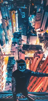 Man with neon mask overlooking vibrant cityscape at night.