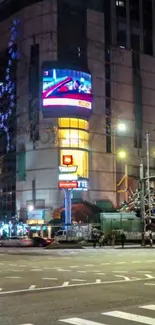 Vibrant city street at night with neon lights and bustling atmosphere.