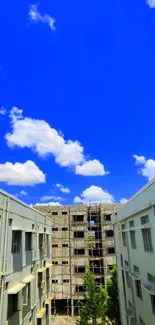 Urban view with blue sky and clouds over buildings.