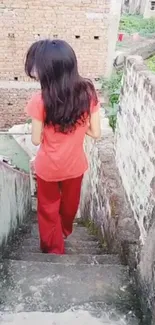 Woman in red walking down an urban staircase.