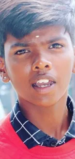 Young person in vibrant red outfit, urban background.