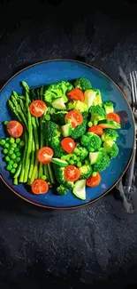 Colorful vegetable plate with asparagus, broccoli, and tomatoes on a blue dish.