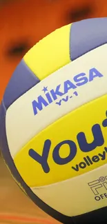 Colorful volleyball on an indoor court with vibrant colors.