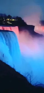 Blue and pink illuminated waterfall at night