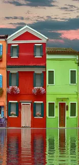 Colorful waterfront houses reflecting on tranquil water.