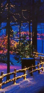 A snowy forest pathway lit by colorful holiday lights.