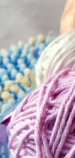 Pastel yarn balls in vibrant colors for a stylish mobile wallpaper.