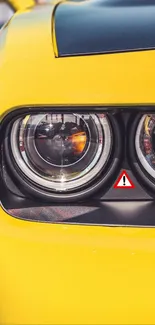 Close-up of vibrant yellow car headlight showcasing modern design elegance.