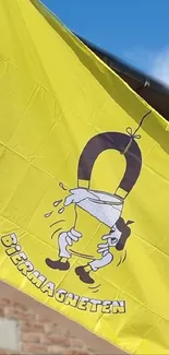 Cartoon magnet on vibrant yellow flag waving in the sky.