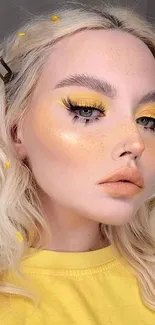 Vibrant yellow makeup look with blonde hair.