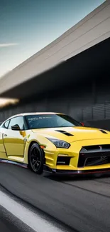 Yellow sports car on a race track at sunset.