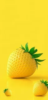 Yellow strawberry with green leaf on bright yellow background.