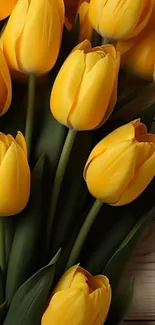 Vibrant bouquet of yellow tulips on wood.