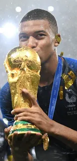 Soccer player celebrates with trophy in blue uniform, capturing victory moment.