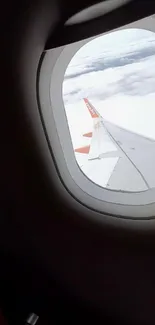 View of sky and clouds through an airplane window.