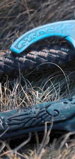 Intricate Viking axe with blue design on wild grass.