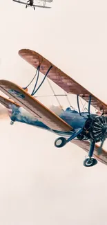 Vintage biplane aircraft flying in the sky, capturing a sense of historical aviation.