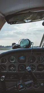 Vintage airplane cockpit with controls and sky view.