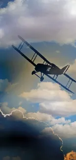 Silhouette of a vintage airplane flying in a vibrant cloudy sky.