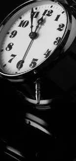 Black and white vintage alarm clock showing time reflection.