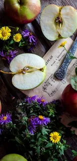 Apples and flowers on rustic wooden table wallpaper.