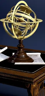 Vintage armillary sphere on wooden table with deep blue background.