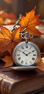 Vintage pocket watch on books with autumn leaves.