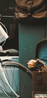Vintage bicycle with suitcase and teal-green background wallpaper.