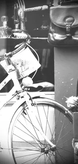 Vintage bike and leather bag in black and white scene.