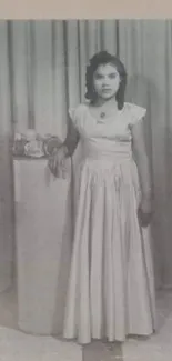 Vintage black and white portrait of a woman in a frame with elegant curtains.