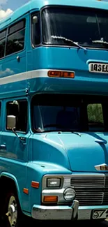 Vintage blue double-decker bus under a clear sky.