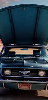 Vintage blue car with open hood on desert road.