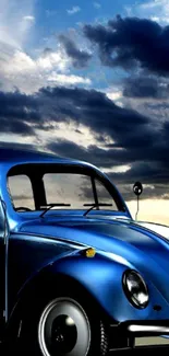 Vintage blue car under a dramatic cloudy sky background.