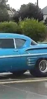 Classic blue vintage car on wet street.