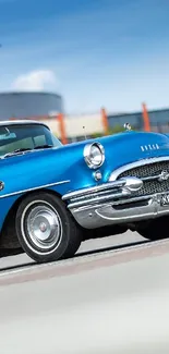 Vintage blue car parked in front of a building under a clear sky.