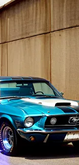 Vintage blue Mustang parked by a wall.