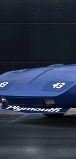 Sleek vintage blue sports car on a dark background.