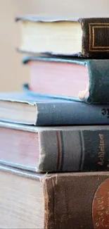 Vintage books stacked elegantly on a neutral background.