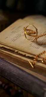 Vintage book with golden charm on wooden table.