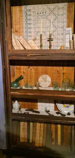 Vintage bookshelf with antiques and books in a wooden cabinet.