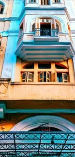 Vintage building facade with balustrades and arched windows in urban scenery.