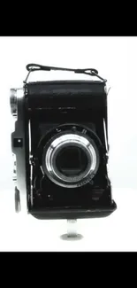 Vintage black and white camera wallpaper for mobile screens.