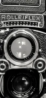 Black and white vintage Rolleiflex camera with sparkles.