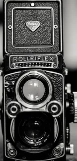 A black and white vintage Rolleiflex camera in close-up.