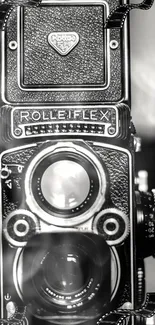 Close-up of vintage Rolleiflex camera in black and white.