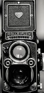 Black and white vintage Rolleiflex camera image.