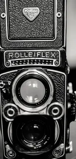 Vintage Rolleiflex camera in monochrome photography style.