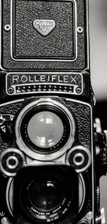 Close-up of vintage Rolleiflex camera in monochrome for mobile wallpaper.